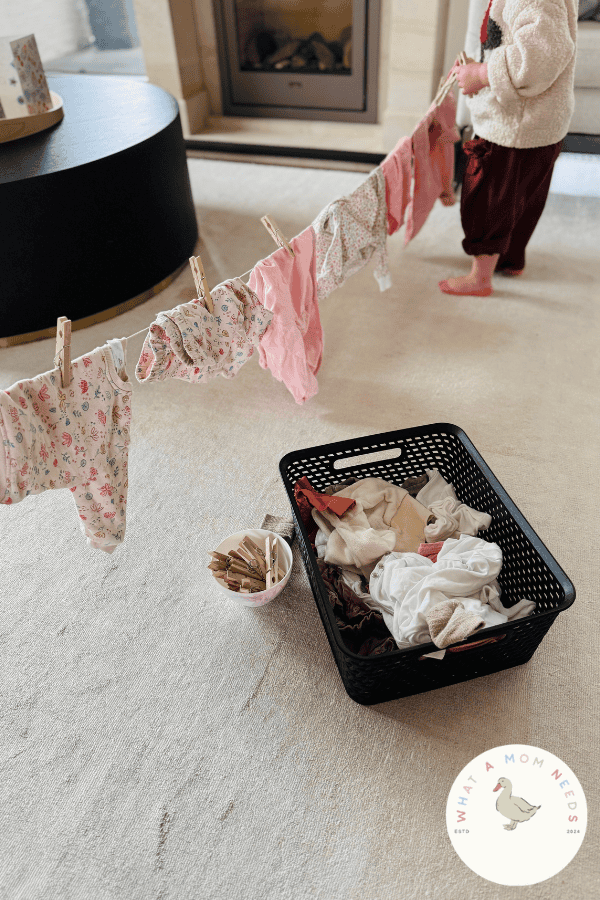 toddler hanging laundry